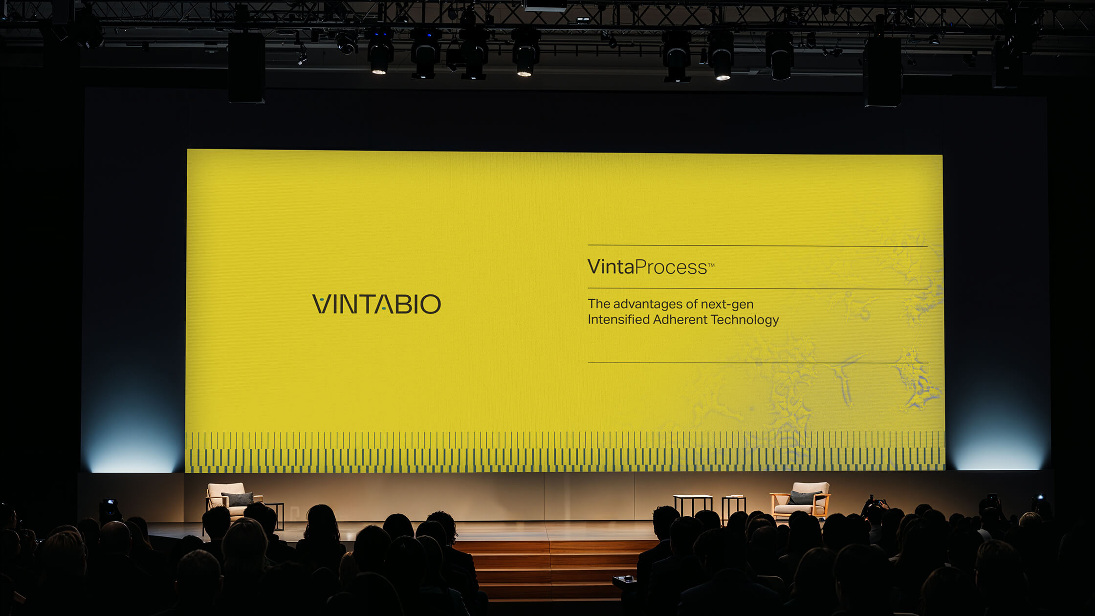 Conference slide by Igawa Design for VintaBio, showcasing the VintaProcess title, logo, and proprietary cell line visual on a vibrant yellow background as part of their cohesive branding system.