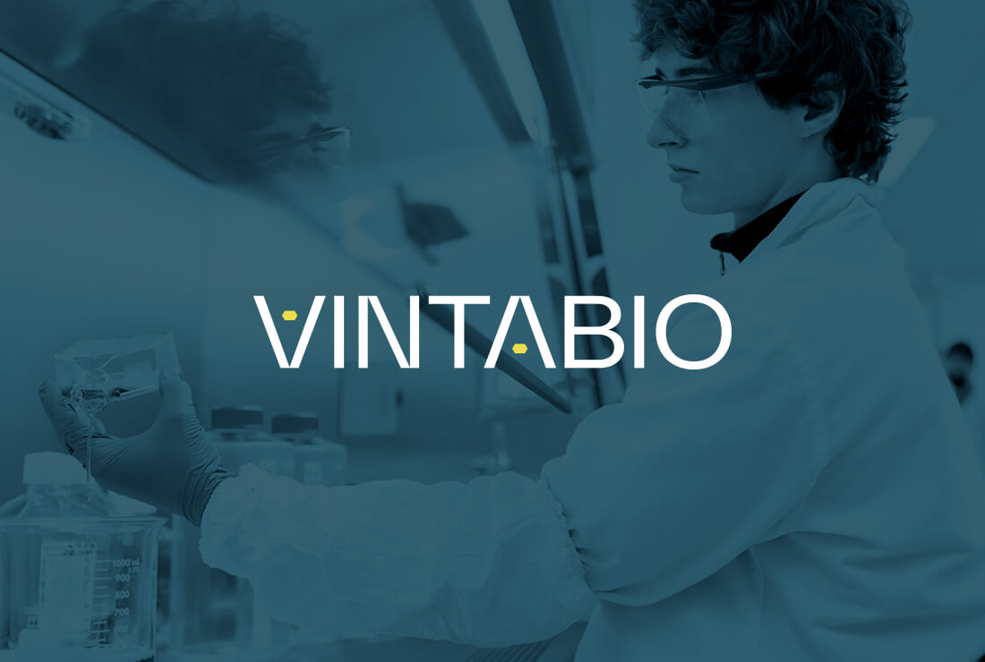 scientist with VintaBio logo